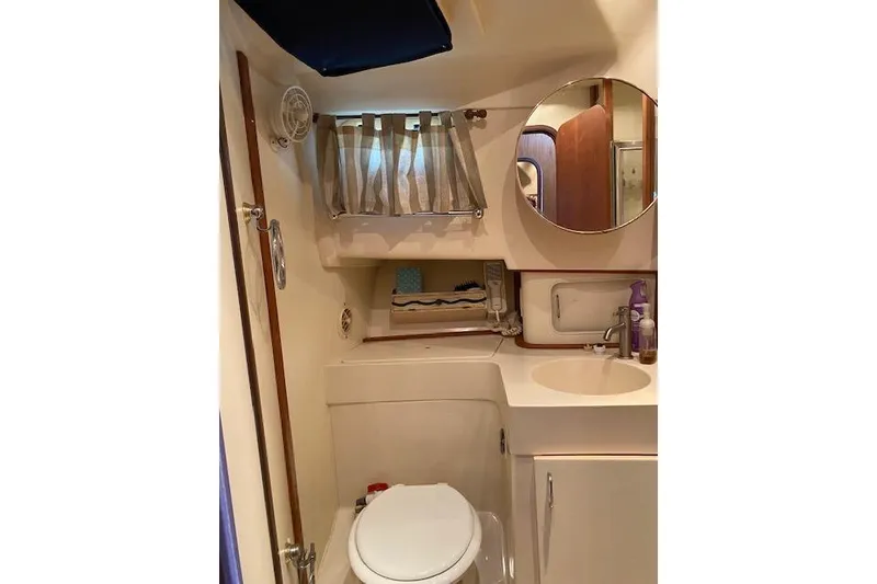 Slide: The Image of 1999 Mainship 350 Trawler bathroom with sink, mirror, and toilet. - 45