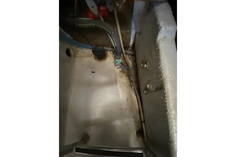 Slide: The Image of 1999 Mainship 350 Trawler engine compartment with visible wiring and plumbing. - 47