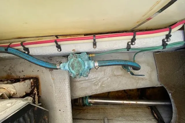 Slide: The Image of Engine room of 1999 Mainship 350 Trawler showing plumbing and wiring details. - 52