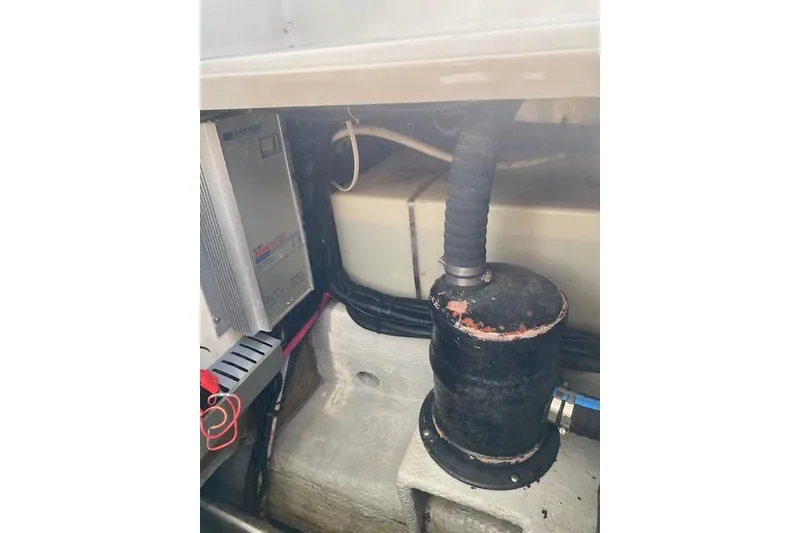 Slide: The Image of Engine compartment of a 1999 Mainship 350 Trawler, showing mechanical components and wiring. - 55