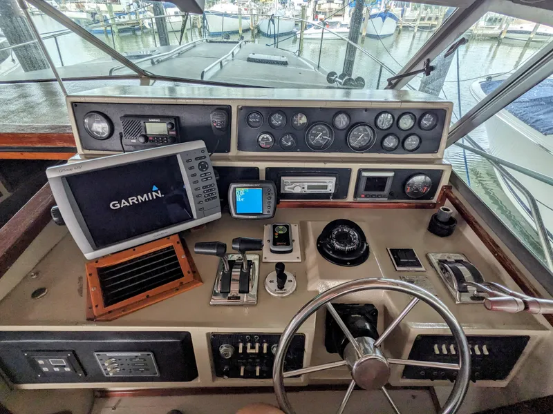Slide: The Image of 1988 Sea Ray 390 Express Cruiser helm with Garmin navigation system and control panel. - 12