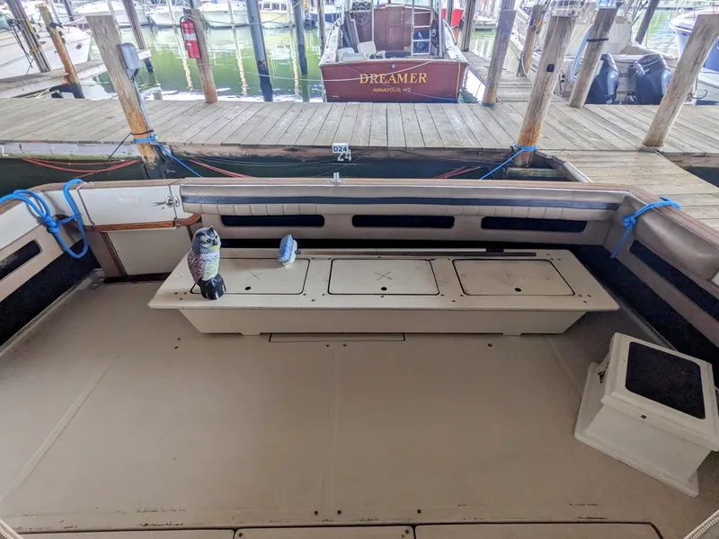 Slide: The Image of 1988 Sea Ray 390 Express Cruiser interior with seating and dock view. - 16