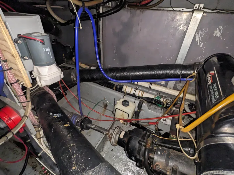 Slide: The Image of Engine room of a 1988 Sea Ray 390 Express Cruiser with visible wiring and components. - 17