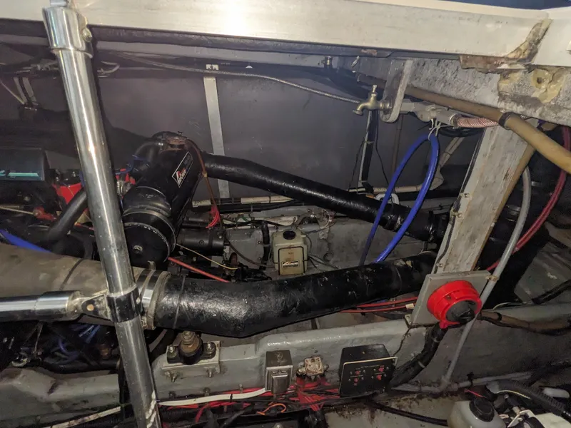 Slide: The Image of Engine compartment of a 1988 Sea Ray 390 Express Cruiser with visible hoses and wiring. - 18