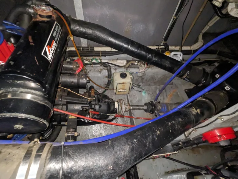 Slide: The Image of Engine compartment of a 1988 Sea Ray 390 Express Cruiser with visible components and wiring. - 19