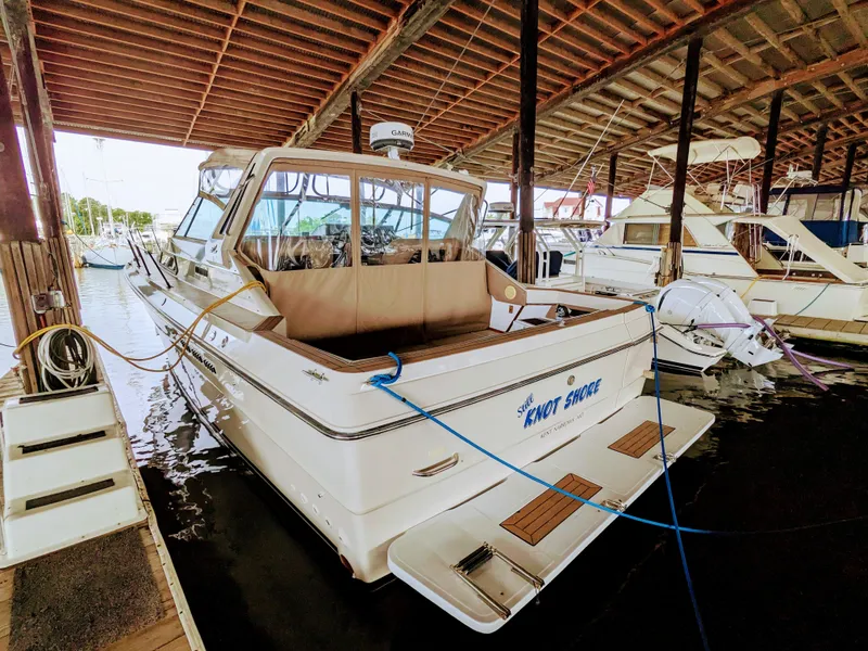 Slide: The Image of 1988 Sea Ray 390 Express Cruiser docked in a covered marina. - 3