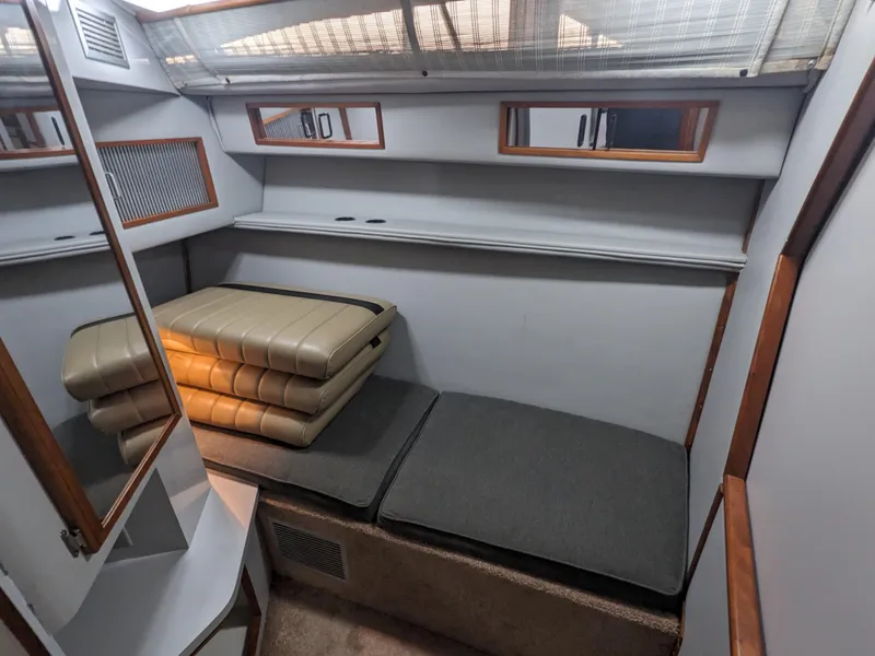 Slide: The Image of 1988 Sea Ray 390 Express Cruiser cabin interior with seating and storage. - 30