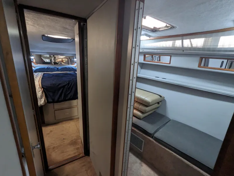 Slide: The Image of 1988 Sea Ray 390 Express Cruiser interior with cozy cabin and sleeping area. - 33