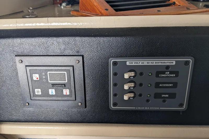 Slide: The Image of Control panel of a 1988 Sea Ray 390 Express Cruiser with electrical distribution switches. - 36