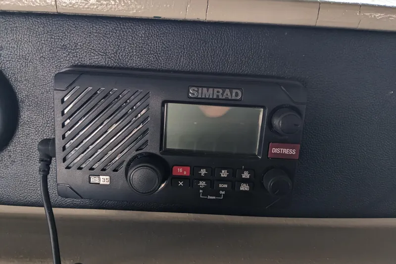 Slide: The Image of Simrad RS35 marine radio on 1988 Sea Ray 390 Express Cruiser dashboard. - 40