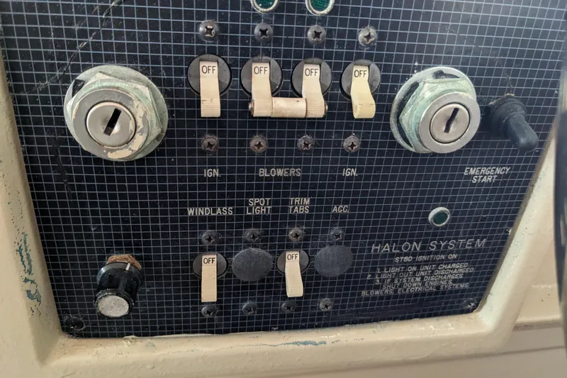 Slide: The Image of Control panel of a 1988 Sea Ray 390 Express Cruiser with switches and ignition keys. - 43