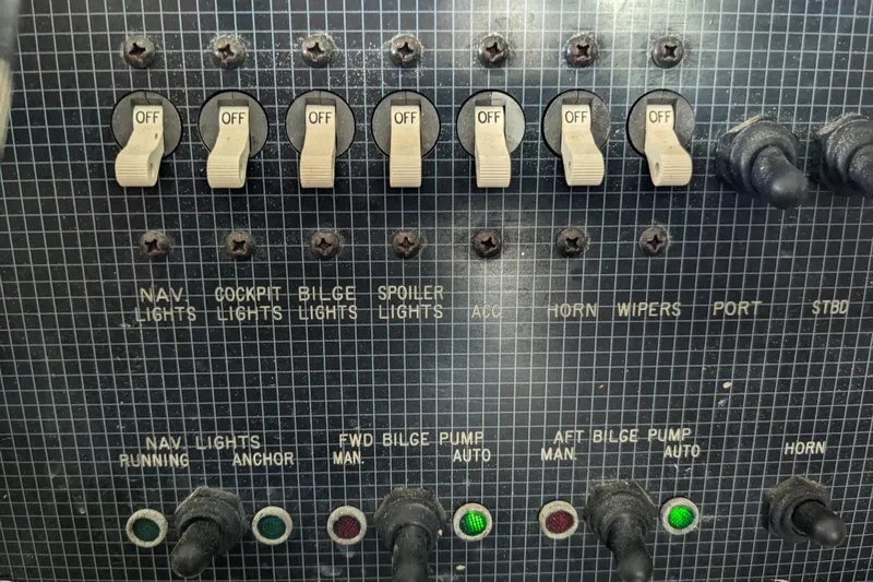 Slide: The Image of Control panel of a 1988 Sea Ray 390 Express Cruiser with labeled switches and indicators. - 45