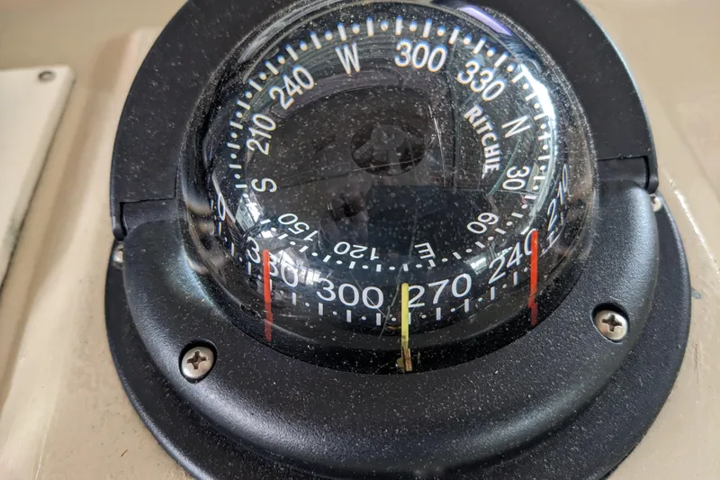 Slide: The Image of Compass on 1988 Sea Ray 390 Express Cruiser, displaying navigational directions. - 48