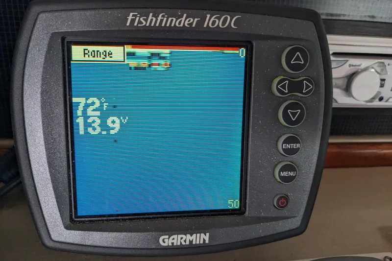Slide: The Image of Garmin Fishfinder 160C display on 1988 Sea Ray 390 Express Cruiser, showing water temperature and depth. - 56