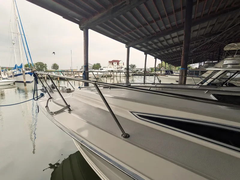 Slide: The Image of 1988 Sea Ray 390 Express Cruiser docked in a marina under a covered shelter. - 7