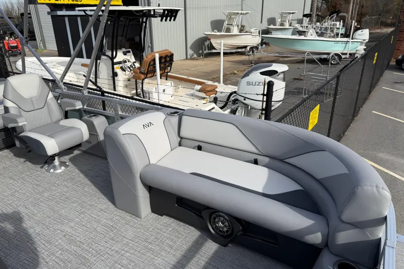 Slide: The Image of 2026 Avalon Venture 85 Versatile rear bench with modern seating, docked near other boats. - 10
