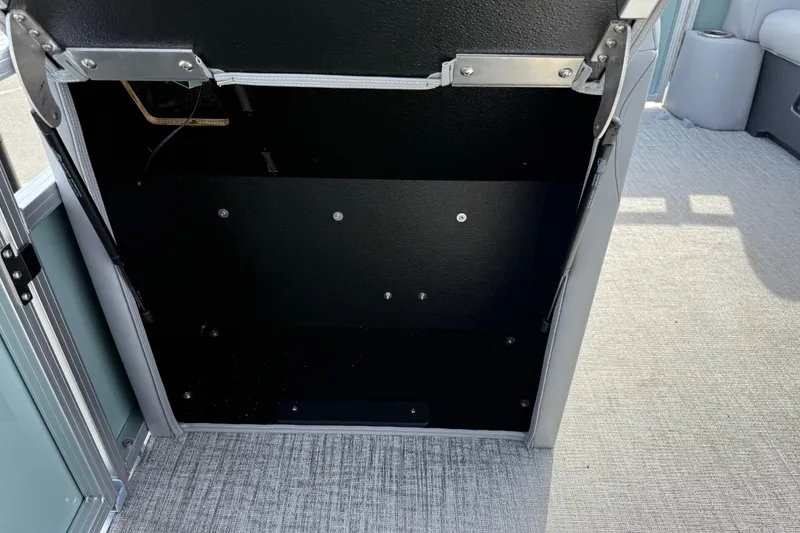 Slide: The Image of Open storage compartment in 2026 Avalon Venture 85 Versatile rear bench boat. - 19