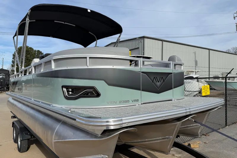 Slide: The Image of 2026 Avalon Venture 85 Versatile Rear Bench pontoon boat with sleek design and canopy. - 2
