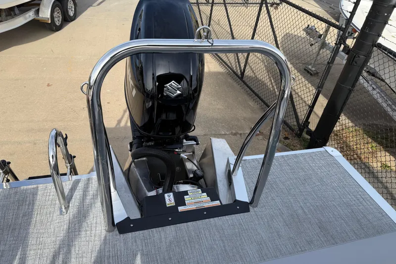 Slide: The Image of 2026 Avalon Venture 85 Versatile rear bench with Suzuki outboard motor, docked near a fence. - 29