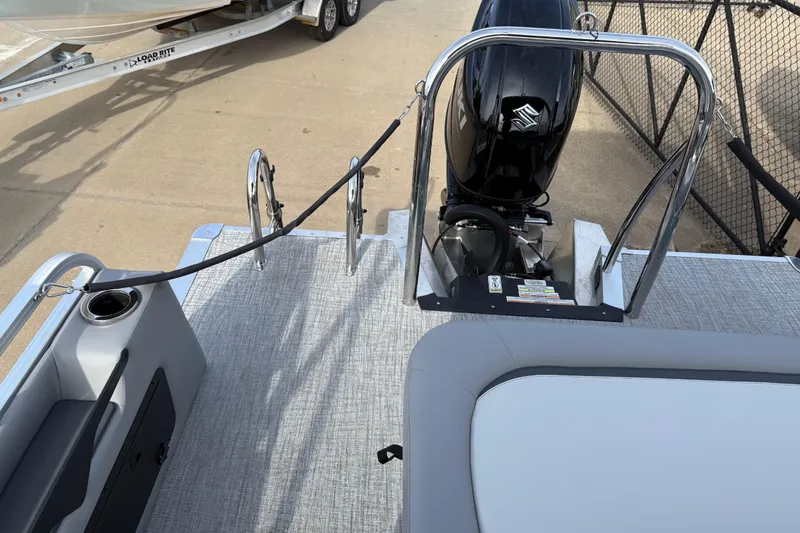 Slide: The Image of 2026 Avalon Venture 85 Versatile rear bench with motor and railing, docked on concrete. - 34