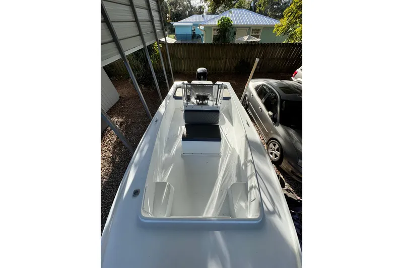 Slide: The Image of 1986 Mako 17 Center Console boat parked under a shelter, viewed from above. - 3