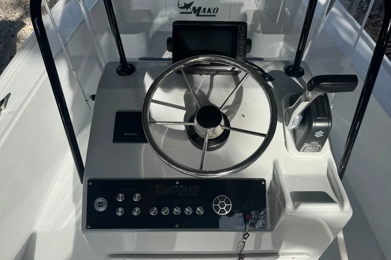 Slide: The Image of 1986 Mako 17 Center Console boat dashboard with steering wheel and controls. - 5