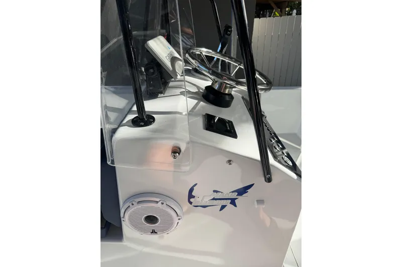 Slide: The Image of 1986 Mako 17 Center Console boat dashboard with steering wheel and speaker. - 7