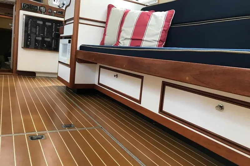 Slide: The Image of Interior of 2001 Wesmac 38 boat with wooden flooring and cushioned seating. - 14