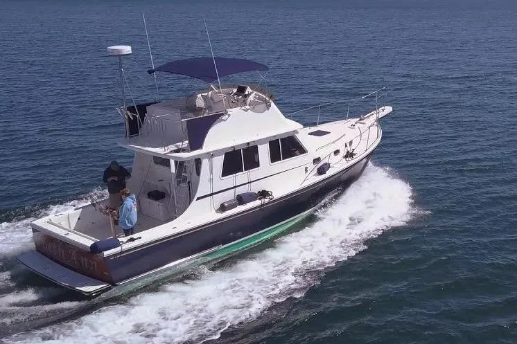 Slide: The Image of 2001 Wesmac 38 boat cruising on open sea. - 2