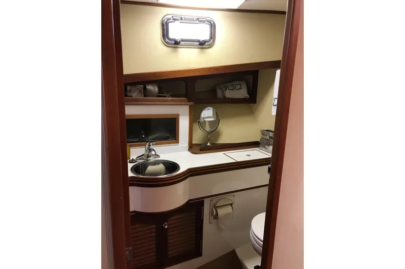 Slide: The Image of 2001 Wesmac 38 yacht bathroom with sink, mirror, and storage shelves. - 22