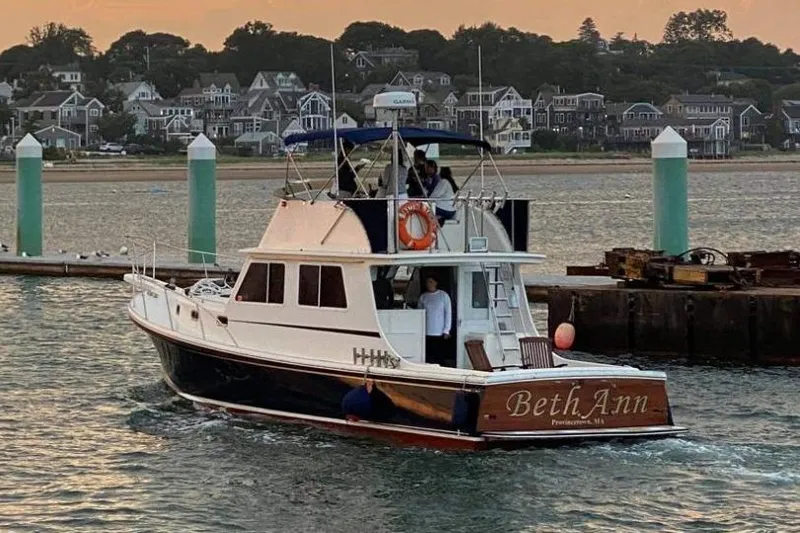 Slide: The Image of 2001 Wesmac 38 boat named "Beth Ann" in a scenic harbor at sunset. - 25