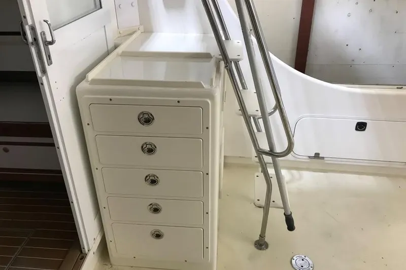 Slide: The Image of Interior of 2001 Wesmac 38 boat with storage drawers and ladder. - 5