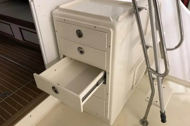 Slide: The Image of Open drawer on 2001 Wesmac 38 boat, showcasing storage space and metal railing. - 6