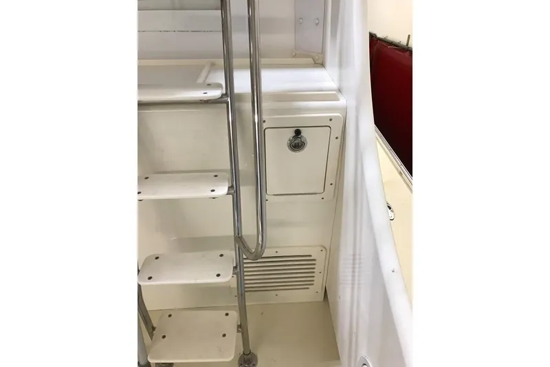 Slide: The Image of Staircase and storage compartment on 2001 Wesmac 38 boat interior. - 7