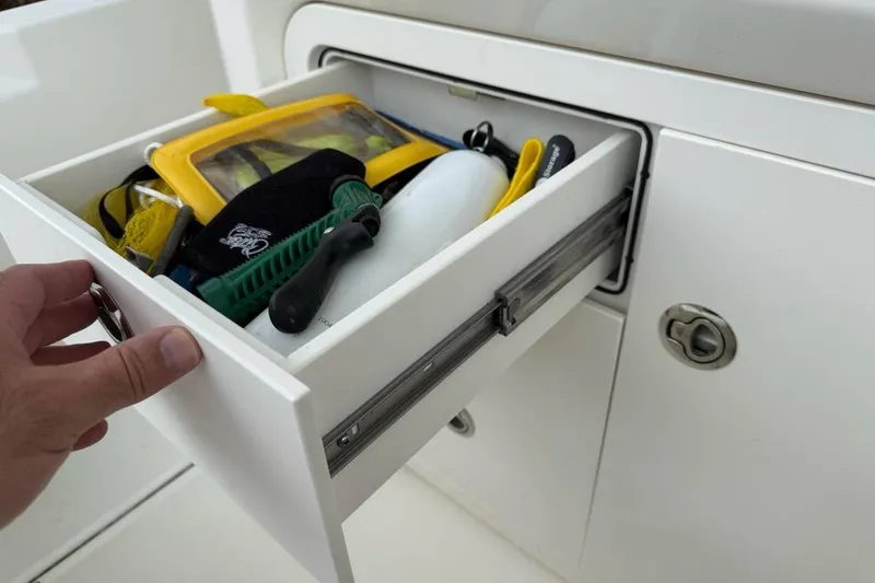 Slide: The Image of 2024 Boston Whaler 250 Dauntless boat hatch detail with secure latching mechanism. - 13