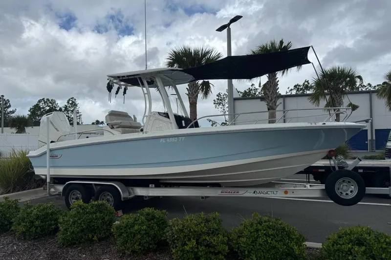 Slide: The Image of 2024 Boston Whaler 250 Dauntless boat storage compartment with rod holders. - 14