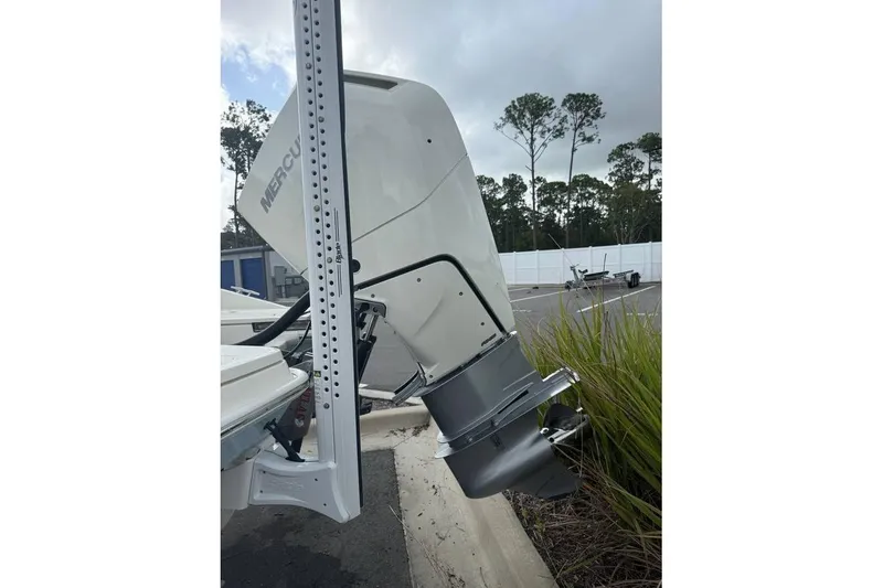 Slide: The Image of 2024 Boston Whaler 250 Dauntless helm with steering wheel, controls, and Simrad display. - 2