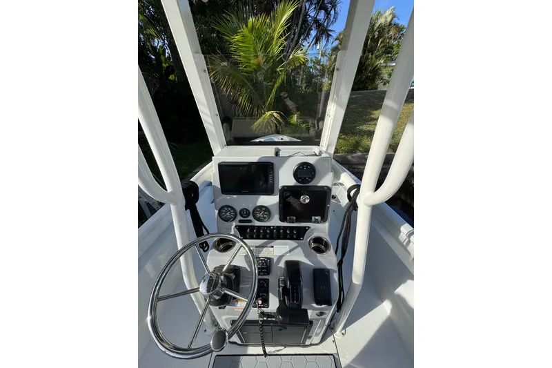 Slide: The Image of 2022 Avid 23 FS Magnum boat console with steering wheel and navigation controls. - 7