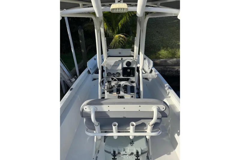 Slide: The Image of 2022 Avid 23 FS Magnum boat interior with steering console and seating. - 8