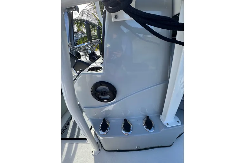 Slide: The Image of 2022 Avid 23 FS Magnum boat console with steering wheel and cup holder. - 9