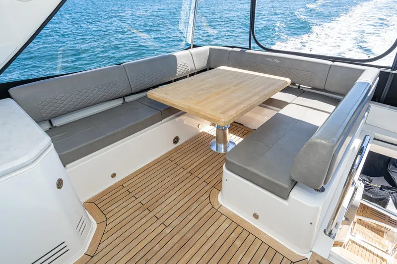 Slide: The Image of 2018 Sea Ray L590 Fly yacht with teak deck and cushioned seating area. - 13