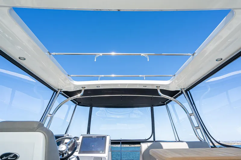Slide: The Image of Interior view of 2018 Sea Ray L590 Fly yacht with clear blue sky. - 14
