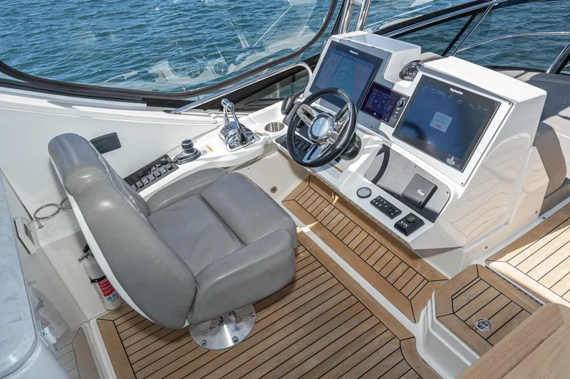 Slide: The Image of 2018 Sea Ray L590 Flybridge helm with modern navigation systems and leather captain's chair. - 20