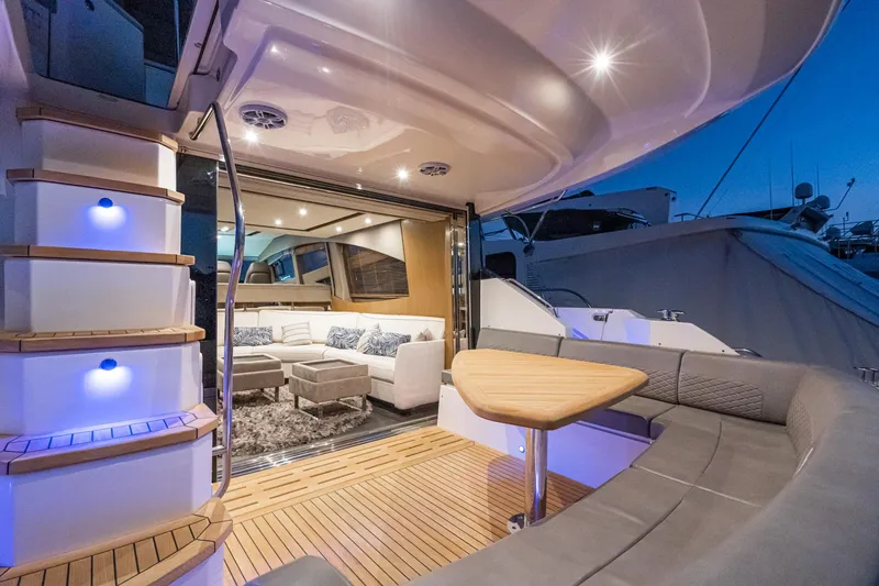 Slide: The Image of 2018 Sea Ray L590 Fly yacht interior with modern seating and ambient lighting. - 25