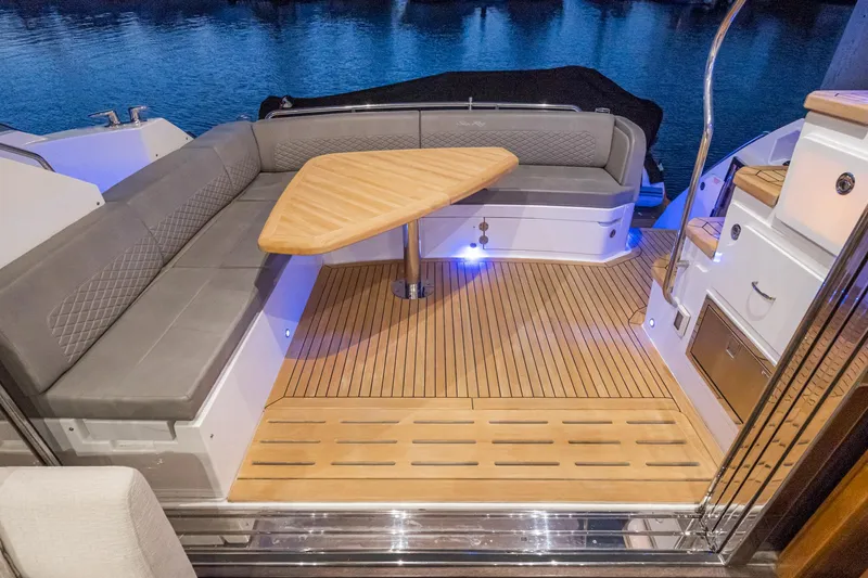 Slide: The Image of 2018 Sea Ray L590 Fly yacht with elegant outdoor seating and wooden deck. - 26