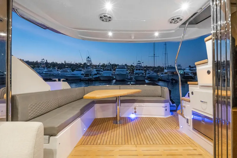 Slide: The Image of 2018 Sea Ray L590 Fly yacht interior with docked boats at sunset. - 27