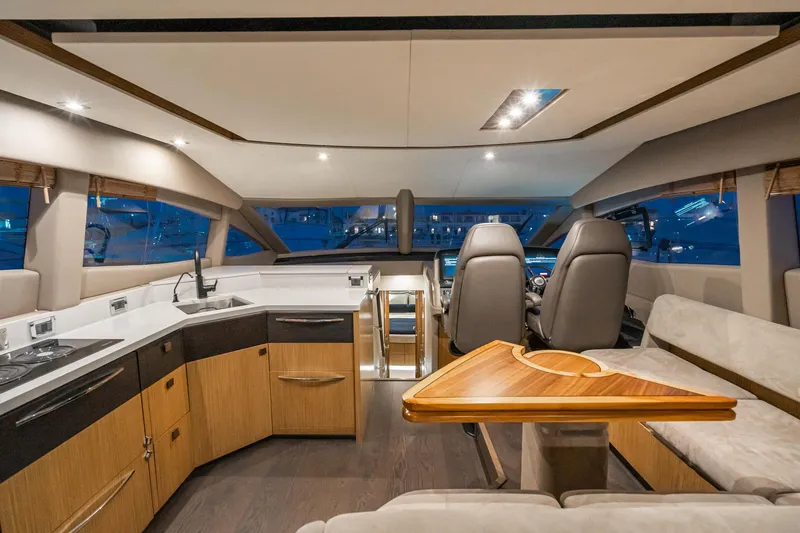 Slide: The Image of Interior of 2018 Sea Ray L590 Fly yacht with modern kitchen and seating area. - 36