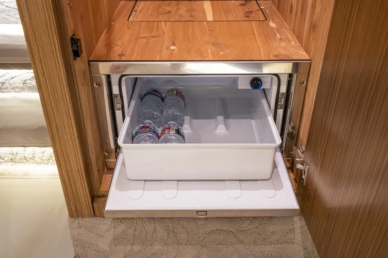 Slide: The Image of Built-in mini fridge in 2018 Sea Ray L590 Fly yacht with water bottles. - 42