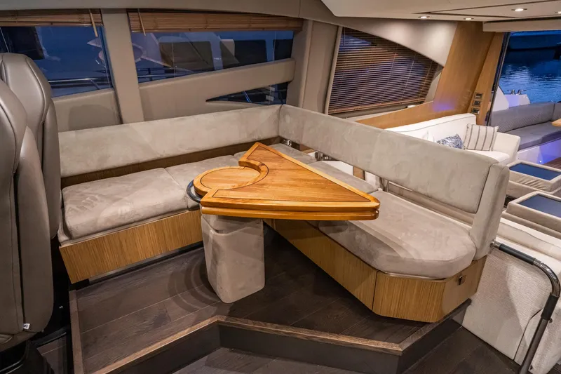 Slide: The Image of Luxurious interior seating area of 2018 Sea Ray L590 Fly yacht with wooden table. - 46