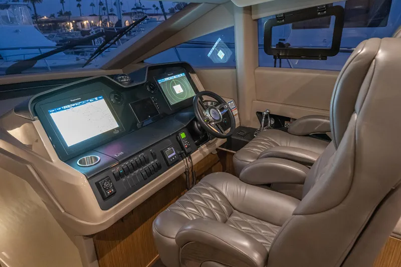 Slide: The Image of 2018 Sea Ray L590 Fly yacht cockpit with advanced navigation systems and luxurious seating. - 49